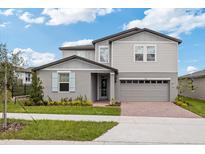 Two story house with light gray siding and blue shutters at 1128 Griffon Ave, Lake Alfred, FL 33850