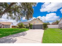 Single-story house with gray garage and basketball hoop at 132 Robbins Rest Cir, Davenport, FL 33896