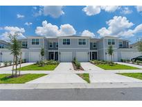 Three-unit townhome building with garages and landscaping at 2609 Bright Jewel St # 2909, Kissimmee, FL 34746