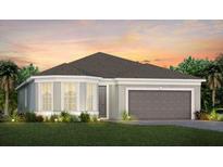 Two-story house with gray roof and garage at 1967 Spring Shower Cir, Kissimmee, FL 34744