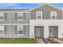 Two-story townhome with gray siding and landscaping at 3954 Lana Ave, Davenport, FL 33897