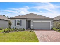 Two-car garage and front yard landscaping at 3116 Legends Preserve Dr, Daytona Beach, FL 32124