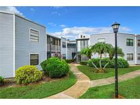 Exterior view of building with landscaping at 3937 Atrium Dr # 5, Orlando, FL 32822