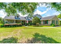 Two-story house with green siding, landscaping, and a walkway at 3202 Misty Morn Ct, St Cloud, FL 34771