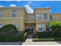Two-story townhome with light yellow exterior and a welcoming porch at 5434 River Rock Rd, Lakeland, FL 33809