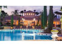 Resort-style pool with clubhouse and lush landscaping at night at 8763 Worldquest Blvd # 5503, Orlando, FL 32821