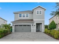 Two-story home with gray siding and a two-car garage at 7481 Marker Ave, Kissimmee, FL 34747