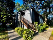 Exterior view of a building with stairs and landscaping at 180 Waterfall Way # 203, Altamonte Springs, FL 32714