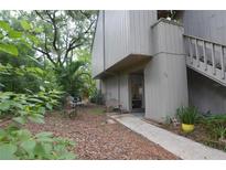 Exterior view of condo with walkway leading to entrance, surrounded by lush landscaping at 116 Crown Oaks Way # 116, Longwood, FL 32779