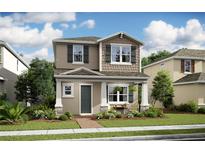 Two-story home with neutral color palette and inviting front porch at 12736 Lavender Bloom Aly # 170, Winter Garden, FL 34787