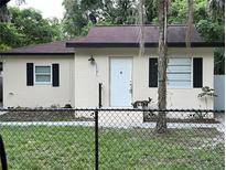 Newly renovated light beige house with chain link fence at 1531 Wauchula St, Intercession City, FL 33848