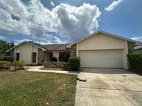 Single-story home with attached garage and landscaped yard at 368 Fairgreen Pl, Casselberry, FL 32707