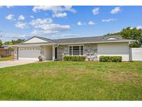 Charming single-story home with stone accents and a spacious lawn at 1484 Patricia St, Kissimmee, FL 34744