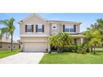 Two-story house with driveway and landscaping at 2601 Eagle Canyon N Dr, Kissimmee, FL 34746