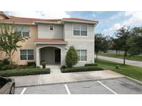 Two-story townhome with front yard and parking at 8951 Bismarck Palm Rd, Kissimmee, FL 34747