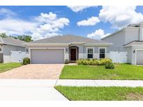 Front view of house with a well manicured lawn at 122 Blue Cypress Drive, Davenport, FL 33837