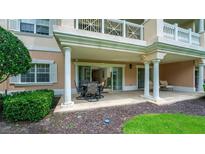 Covered patio with seating area and access to interior at 1350 Centre Court Ridge # 103, Reunion, FL 34747