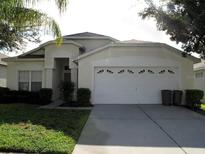 One-story house with two-car garage and lawn at 2239 Wyndham Palms Way, Kissimmee, FL 34747