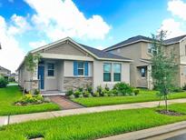 Charming one-story home with stone accents and landscaped yard at 16253 Pebble Bluff Loop, Winter Garden, FL 34787