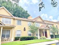 Tan two-story townhome with manicured lawn at 837 Grand Regency Pt # 207, Altamonte Springs, FL 32714