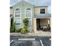 Green house exterior with landscaping and parking at 2444 Summerfield Way # 1, Kissimmee, FL 34741