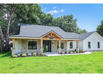 All-brick home with a welcoming front porch and attached two-car garage at 19906 Eldorado Dr, Eustis, FL 32736