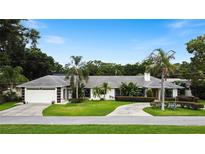 Single-Gathering home with a two-car garage and circular driveway at 342 Maple Dr, Longwood, FL 32750