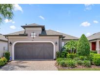 Single-story house with a brown garage door and landscaping at 1282 Zeek Ridge St, Clermont, FL 34715