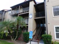 Two-story light beige apartment building with stairs and a walkway at 208 Afton Sq # 307, Altamonte Springs, FL 32714