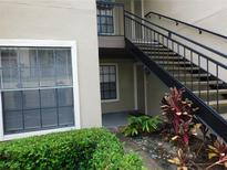 Exterior view of condo building with stairs and landscaping at 200 Afton Sq # 102, Altamonte Springs, FL 32714