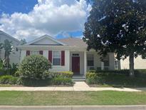 Charming one-story home with red door at 7416 Soiree Way, Reunion, FL 34747