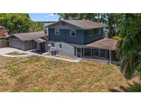 Two-story house with a screened porch and lake view at 1149 Shady Cove E Rd, Haines City, FL 33844