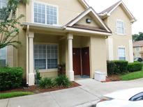 Exterior view of a tan two-story condo building with entryway at 824 Grand Regency Pt # 102, Altamonte Springs, FL 32714
