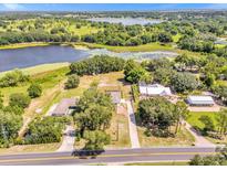 Aerial view showing a house near a lake at 9339 Lakeshore Dr, Clermont, FL 34711