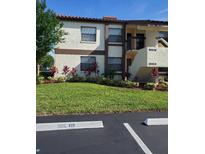 Well-maintained condo building with landscaping and private parking at 6182 Willowpointe # B201, Orlando, FL 32822