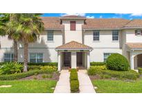 Two-story townhome with a shared walkway and manicured landscaping at 1552 Plunker Dr, Davenport, FL 33896