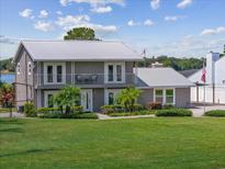 Two-story home with metal roof and large yard at 7220 Grace Rd, Orlando, FL 32819