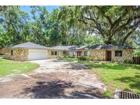 Stone house with a two car garage at 3355 Scarlet Dr, Sanford, FL 32773