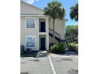 Tan building exterior with black metal staircase and parking at 1059 S Hiawassee Rd # 1824, Orlando, FL 32835
