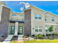 Modern two story home with green door at 962 Splash Shot Pl, Davenport, FL 33896