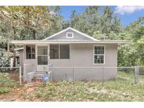 Front view of a renovated gray house with fenced yard at 448 Nw 18Th Ave, Ocala, FL 34475