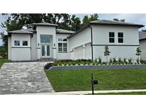 Two-story house with a gray stone driveway and landscaped yard at 555 Sanctuary Golf Pl, Apopka, FL 32712