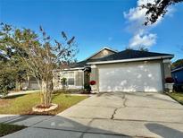 Charming single-story home with a two-car garage and landscaped front yard at 428 Short Pine Cir, Orlando, FL 32807