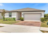 Single-story home with attached garage and brick driveway at 531 Tortugas St, Haines City, FL 33844