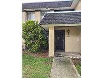 Condo building exterior featuring a walkway and landscaping at 2222 Silver Pines Pl # 902, Orlando, FL 32808