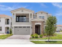 Two-story house with a gray exterior, two-car garage, and landscaping at 13839 Larkton Ln, Orlando, FL 32832