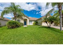 One-story home with a two-car garage and lush landscaping at 4028 Navigator Way, Kissimmee, FL 34746