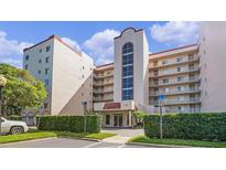 Exterior view of a condo building with landscaping and parking at 1150 Carmel Cir # 408, Casselberry, FL 32707