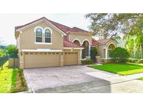 Two-story house with a double-car garage and manicured lawn at 9060 Heritage Bay Cir, Orlando, FL 32836