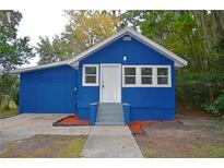 Blue house exterior with a gray walkway and landscaping at 647 S Delaware Ave, Deland, FL 32720